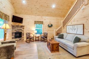 a living room with a couch and a fireplace at Serene Kentucky Cabin with Fireplace and Fire Pit! in Williamstown