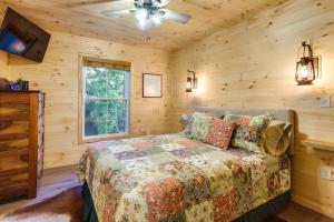a bedroom with a bed in a log cabin at Serene Kentucky Cabin with Fireplace and Fire Pit! in Williamstown