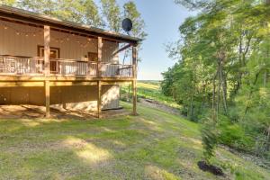 a house with a wrap around porch with a yard at Serene Kentucky Cabin with Fireplace and Fire Pit! in Williamstown