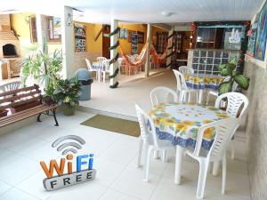 a table and chairs on the porch of a restaurant at Casa e Praia Hospedaria in Arraial do Cabo