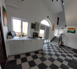 a kitchen with a checkered floor in a room at Castle Csányi in Livezeni
