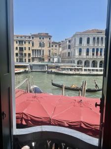a view of a canal with a gondola on the water at Royal Rialto Apartment - Grand Canal View in Venice