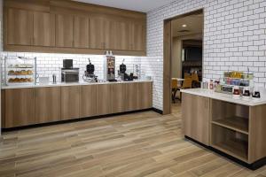 a kitchen with wooden cabinets and a counter top at Residence Inn by Marriott Tuscaloosa in Tuscaloosa