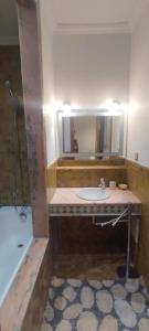 een badkamer met een wastafel en een spiegel bij Marrakech Palmeraie village in Marrakesh