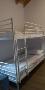 two bunk beds in a room with a ladder at Two Bedroom 2 Bathroom House in Fanari