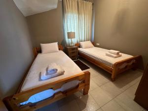 a bedroom with two beds with towels on them at Spenny Sunrise Apartment in Xiropigado