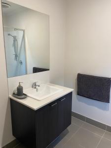 a bathroom with a sink and a mirror at Wodonga House Huon hill in Bandiana +7 photos