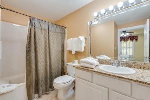 a bathroom with a toilet and a sink and a shower at Calypso Resort - Direct gulf front Condo with king master, and Free Wi-Fi in Panama City Beach