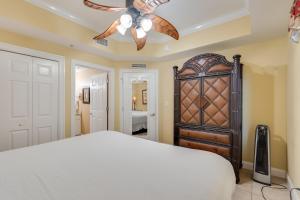 a bedroom with a bed and a ceiling fan at Calypso Resort - Direct gulf front Condo with king master, and Free Wi-Fi in Panama City Beach