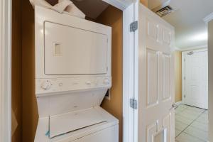 a laundry room with a washer and dryer at Calypso Resort - Direct gulf front Condo with king master, and Free Wi-Fi in Panama City Beach