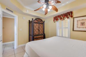 a bedroom with a bed and a ceiling fan at Calypso Resort - Direct gulf front Condo with king master, and Free Wi-Fi in Panama City Beach