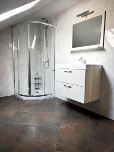 a bathroom with a shower and a sink and a mirror at La casa de Mimi 
