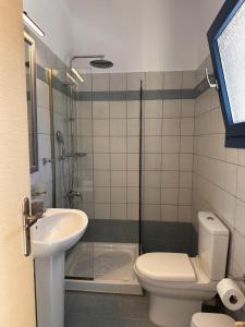 a bathroom with a shower and a toilet and a sink at San Giorgio Leros in Drymonas +48 photos