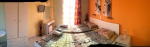 a room with a bed in a room with a window at Athina Studios in Argasi