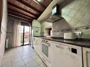 a kitchen with white appliances and a large window at La Casa Vieja - 12010 in Ajo