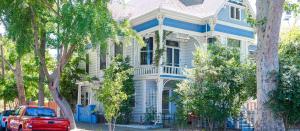 a red truck parked in front of a blue house at IreneHouse Victorian INN in Sacramento