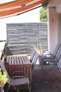 a patio with chairs and a table and a fence at SPA-Apartment mit Sauna in Ulm-Böfingen in Ulm