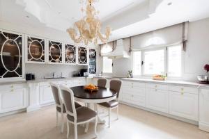 a kitchen with a table and chairs and a chandelier at Luxurious & Exclusive Villa, 10 min from the beach in Herzliya