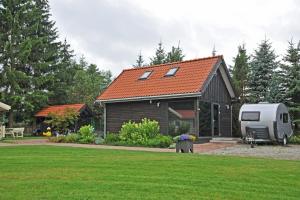 a house with an rv parked next to a yard at YACHT CLUB WEJSUNY in Ruciane-Nida