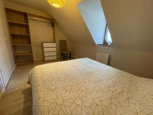 a bedroom with a large bed in a attic at T2 cœur de ville thème bohème in Rodez