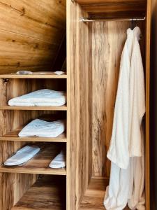 a wooden closet with towels and towels at Deadsea OCTAGON in Madaba