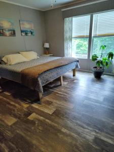 a bedroom with a bed and a large window at Riley's Pad Master Suite in Sevierville