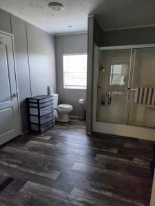 a bathroom with a toilet and a glass shower at Riley's Pad Master Suite in Sevierville