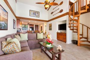 a living room with a couch and a table at Country Club Villas 302 in Kailua-Kona