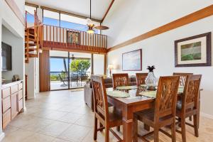 a dining room with a table and chairs at Country Club Villas 302 in Kailua-Kona