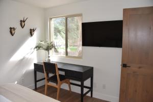 a bedroom with a desk and a window at Canyons Creekside 3b3ba Townhouse 1 Block to Ski Lift in Park City