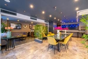 a lobby with tables and chairs and a couch at La Wisteria Boutique Hotel Istanbul in Istanbul