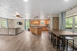 a kitchen and living room with a table and a couch at Hot Tub! LRG Home! Sleeps 22!Near Ithaca! Dogs OK in Lansing