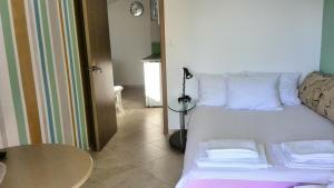 a room with a bed with a table and a lamp at Apartments Mila Krimovica in Budva