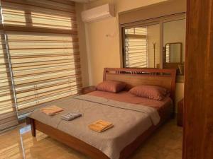a bedroom with a bed with two towels on it at The Pine Tree Chalet in Jerash