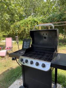 a barbecue grill sitting on top of a table at Pet Friendly Graham Home Route 66 at The Mistletoe Farm in Graham