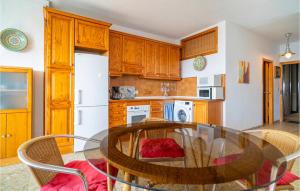 a kitchen with a table and chairs and a refrigerator at Awesome Apartment In Málaga in Málaga