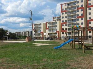 a playground with a blue slide in a park at Apartamento en Ricaurte, Arrayanes de Peñaliza in Ricaurte