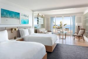 a hotel room with two beds and a view of the ocean at The Ritz-Carlton, Fort Lauderdale in Fort Lauderdale