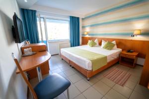 Postel nebo postele na pokoji v ubytování Hotel Apollo