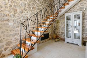a staircase in a room with a stone wall at Luxury Villa Navis in Orebić +63 photos