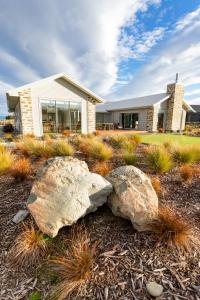 two large rocks in front of a house at Boundary Retreat Twizel in Twizel