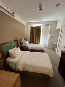 a hotel room with two beds and a window at Nash Hotel in Berkeley