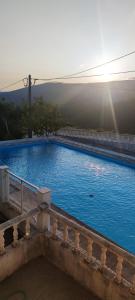 a large blue swimming pool sitting on top of a balcony at Casa do Monte in Castro Daire