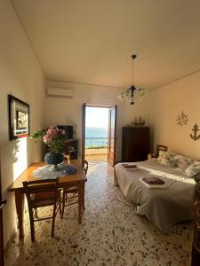 a bedroom with a bed and a table with flowers on it at Da Nonna Nicoletta in Furore