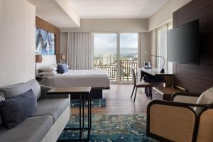 a hotel room with a bed and a desk at San Juan Marriott Resort and Stellaris Casino in San Juan