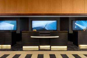 a lobby with two large televisions on a wall at Crystal Gateway Marriott in Arlington