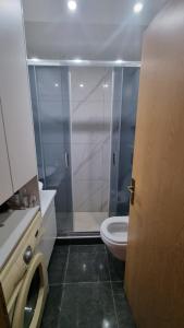a bathroom with a toilet and a glass shower at Aleksandar in Pirot +19 photos