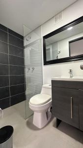 a bathroom with a toilet and a shower and a sink at Apartamento Panoramico en Poblado, Medellin in Medellín