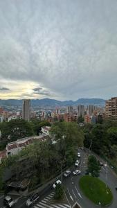 a view of a city with cars on a street at Apartamento Panoramico en Poblado, Medellin in Medellín