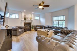 a living room with leather furniture and a fireplace at Prime Peoria Retreat with Deck and Fireplace! in Peoria